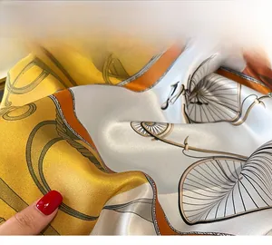 Détail d'un foulard en soie montrant la couture de finition et les motifs de chaînes