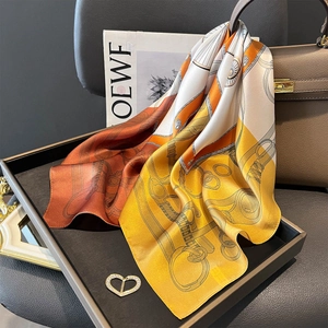 Carré en soie de luxe avec imprimé chaîne et boucle cœur sur une poignée de sac en cuir