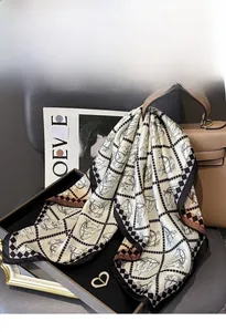 Detail of silk twill scarf featuring equestrian motifs draped on a luxury handbag