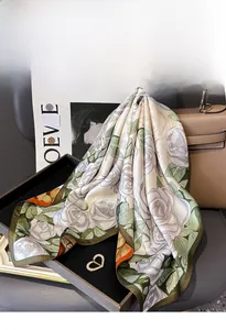 Close-up of a double-sided floral silk scarf on a handbag with premium texture details