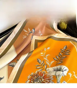 Detail of silk scarf with orange floral prints and fine triangle needle stitching edges