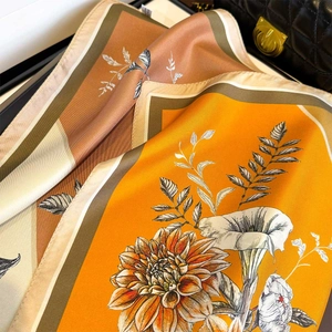 Elegant silk twill scarf with orange floral print and contrasting beige borders