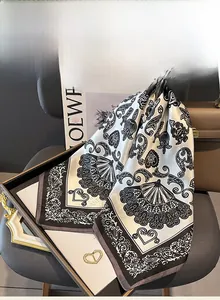 Detail of silk scarf featuring elegant black and white baroque prints and fan patterns