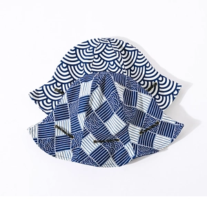 Close-up of Japanese wave pattern sun hats with adjustable drawstrings on white background