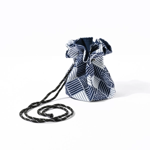 Detail of navy blue Japanese drawstring hat bag with geometric patterns for camping