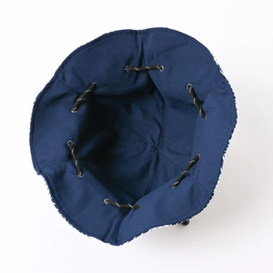Close-up of bucket hat interior showing neat stitching and adjustable black drawstring