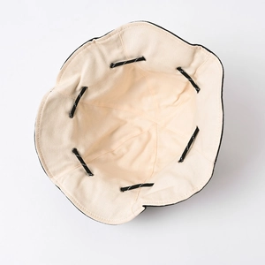 Detail view of cotton sun hat interior with adjustable drawstring and metal eyelets