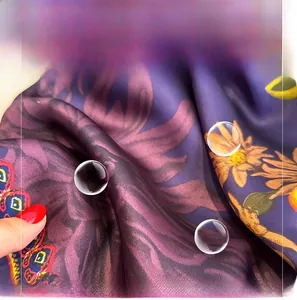 Macro shot of soft purple imitation silk fabric with floral patterns and smooth texture