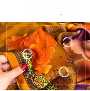 Detail of soft faux silk scarf featuring floral digital print and smooth drape texture