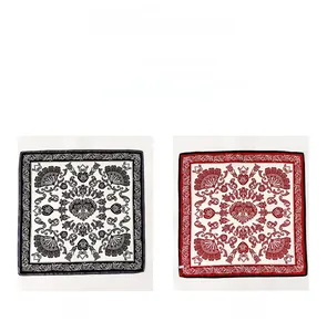 Detail of double-sided silk scarf featuring black-white and red-white paisley patterns