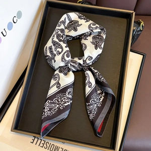 Elegant black and white silk twill square scarf with red edges in a stylish loop display