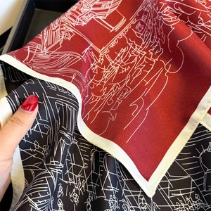 Close-up of silk twill scarf showing detailed architectural print and fine texture