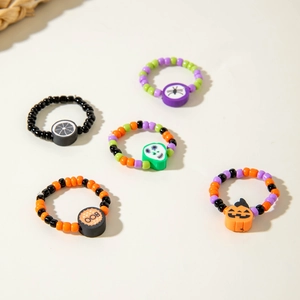 Five-piece Halloween beaded ring set featuring pumpkin, spider and skull charms