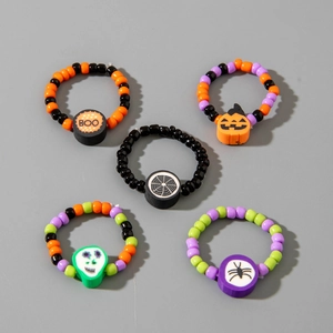 Halloween beaded ring set featuring pumpkin, skull, and spider charms on elastic bands