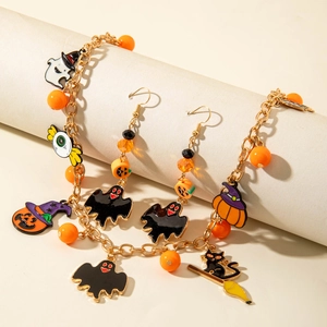 Halloween jewelry set with pumpkin, ghost and bat charms on golden metal chain links