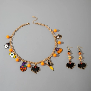 Halloween jewelry set with gold necklace and earrings featuring pumpkin and ghost charms