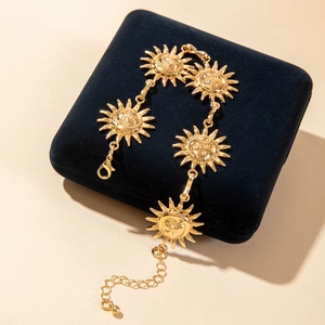 Vintage gold sunflower sun pendant anklet on blue velvet display pillow