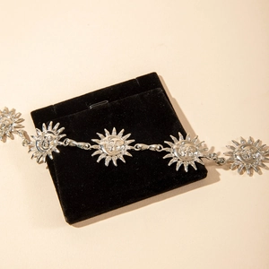 Detail of vintage silver sunflower anklet with celestial face charms and gift bag
