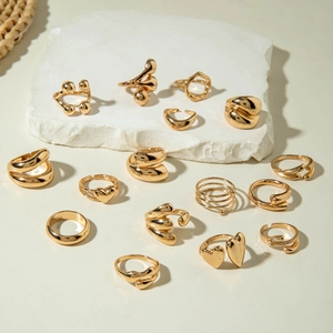 Collection of oversized gold irregular and heart-shaped open rings in minimalist style