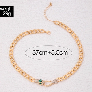 Close-up of gold snake head necklace with green gems and weight 29g specifications