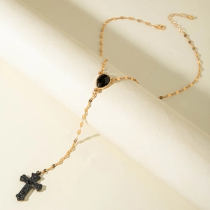 Gold-tone cross and heart multi-layer necklace with black drop gemstone and diamond accents