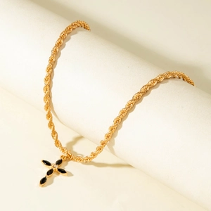 Gold rope chain necklace featuring a vintage cross pendant with black marquise gemstones