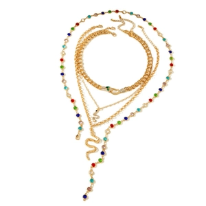 Layered gold snake pendant necklace set with colorful crystals in a minimalist Y-shape style