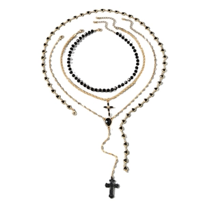 Gold layered necklace set featuring black heart and cross pendants on varied chains