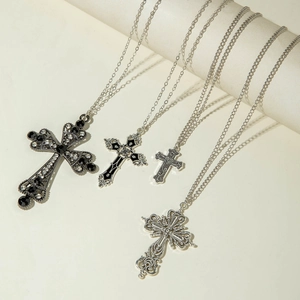 Detail of four retro Gothic cross necklaces with black rhinestones and hollow patterns