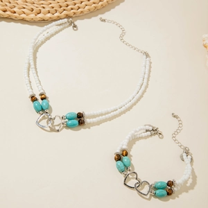 Bohemian seed bead turquoise jewelry set featuring interlocking silver heart pendant