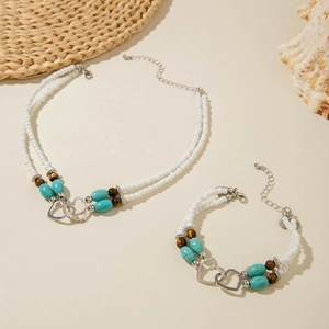 Bohemian turquoise bead jewelry set with double strands and interlocking metal hearts