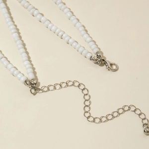 Detail of silver lobster clasp and extension chain on white bohemian beaded jewelry set