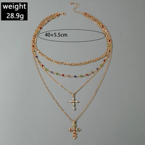Detail view of multi-layer gold cross necklace with colorful zircons and 28.9g weight