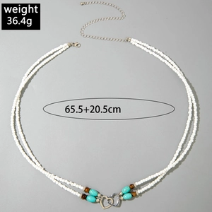 Detail view of double layer white seed bead body chain with silver heart and turquoise