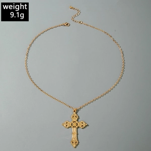 Detailed macro view of vintage gold hollow cross pendant with weight mark of 9.1g