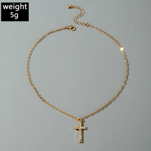 Close-up of golden cross necklace with zircons and lobster clasp, weighing 5g