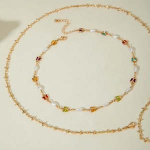 Collier doré multi-rangs avec pendentifs papillons colorés, perles et croix étoiles