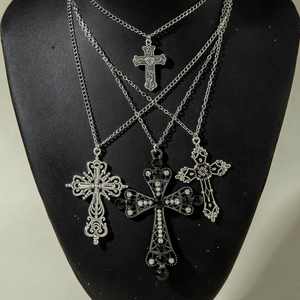 Retro multi-layered silver cross necklace set with zircon pendants on a black neck bust