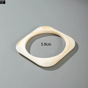 Detail view of square acrylic bangle in cream beige with 5.9cm inner diameter size