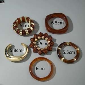 Detailed view of 6-piece chunky acrylic bracelet set with amber resin and leopard beads