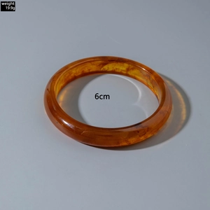 Detail of amber acrylic bangle with 6cm inner diameter and 19.9g weight specifications
