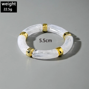 Detail view of acrylic beaded bracelet with marble texture and gold metallic spacers