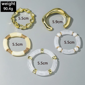 Detail view of 5-piece chunky acrylic beads and gold metal bangle bracelet set
