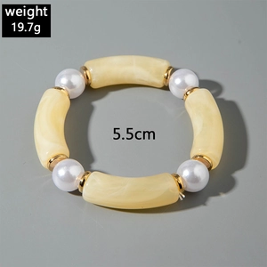 Detail view of chunky acrylic marble beads and faux pearls with gold spacers