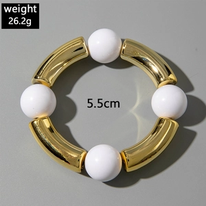 Detail of beaded bracelet with gold curved tubes and white resin beads, 26.2g weight