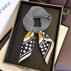 Classic silk square scarf with houndstooth and polka dot patterns on a gift tray