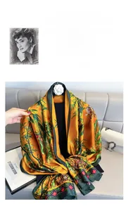 Detailed view of luxury orange and emerald green silk scarf with bamboo floral prints