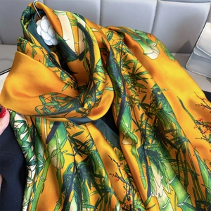 Luxurious bright orange silk-like scarf with traditional green bamboo and red plum prints