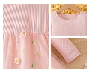 Detail of pink mesh tulle skirt with white and yellow daisy flower embroidery