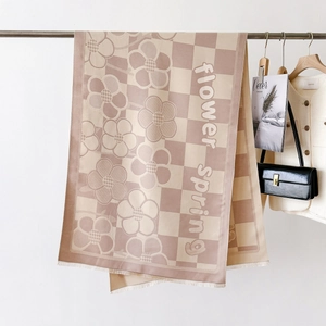 Detail of checkered floral scarf with soft fringes and flower spring text print
